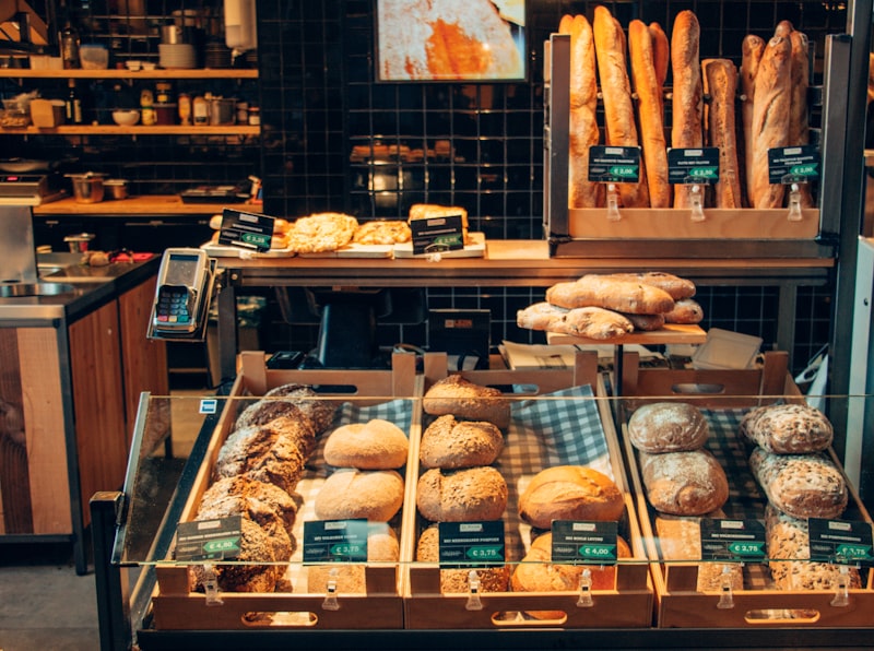 Freshly baked artisan pastries and croissants with a golden crust on a wooden board